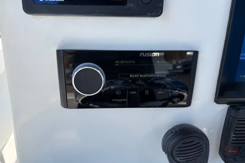 Slide: The Image of Fusion Bluetooth stereo system on 2016 Parker 2100 Center Console boat dashboard. - 12