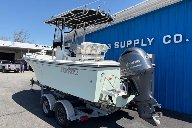 Slide: The Image of 2016 Parker 2100 Center Console boat with Yamaha engine on trailer at marine supply store. - 2