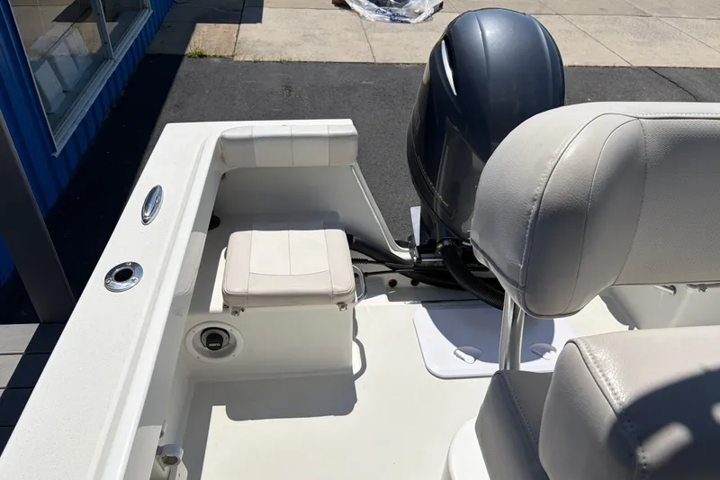 Slide: The Image of 2016 Parker 2100 Center Console boat interior with seating and motor. - 21