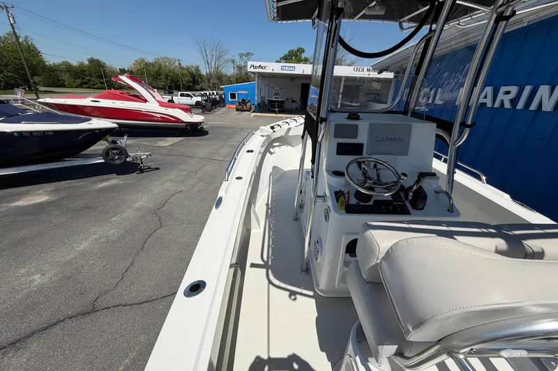 Slide: The Image of 2016 Parker 2100 Center Console boat at a marina with other boats. - 22