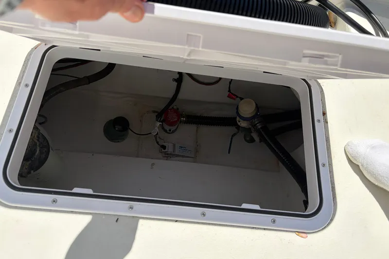 Slide: The Image of Open hatch on a 2016 Parker 2100 Center Console boat, revealing internal components. - 24