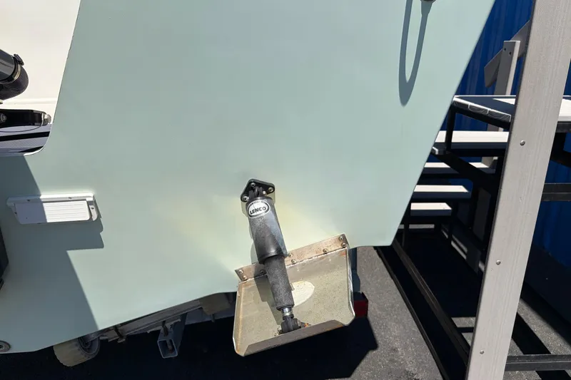 Slide: The Image of 2016 Parker 2100 Center Console boat with Lenco trim tab, docked on a sunny day. - 26
