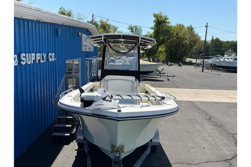 Slide: The Image of 2016 Parker 2100 Center Console boat with Garmin equipment, parked outside a blue supply company building. - 3