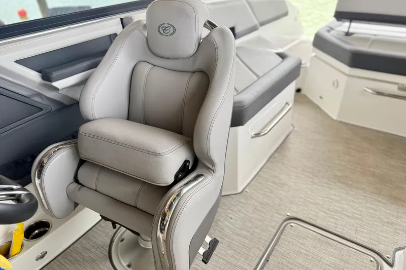 Slide: The Image of 2023 Cobalt R6 boat interior with luxurious gray captain's chair and sleek design. - 11