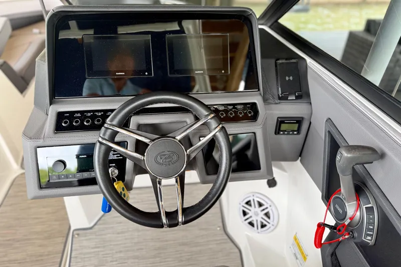 Slide: The Image of 2023 Cobalt R6 boat dashboard with steering wheel and control panel. - 12