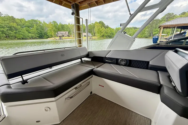 Slide: The Image of 2023 Cobalt R6 boat interior with sleek seating, overlooking a serene lake view. - 17