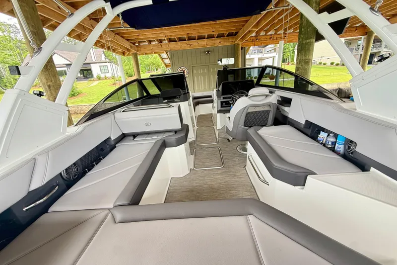Slide: The Image of 2023 Cobalt R6 boat interior with spacious seating and modern design under a wooden canopy. - 18