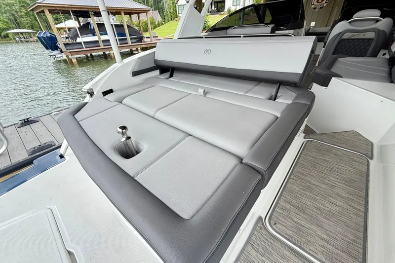 Slide: The Image of 2023 Cobalt R6 boat with sleek seating and modern design by a lakeside dock. - 20