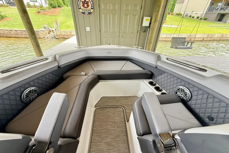 Slide: The Image of 2023 Cobalt R6 boat interior with luxurious seating and modern design at a lakeside dock. - 5