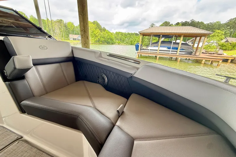 Slide: The Image of Luxurious seating on a 2023 Cobalt R6 boat, docked by a scenic lakeside. - 8