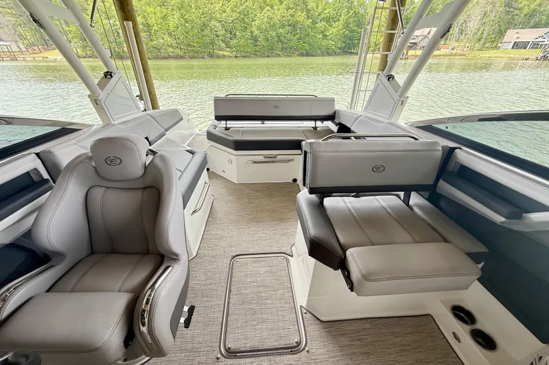 Slide: The Image of 2023 Cobalt R6 boat interior with luxurious seating and scenic lake view. - 9