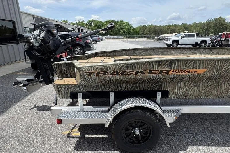 Slide: The Image of 2026 Tracker Grizzly 1756 T Marsh boat on trailer, parked outdoors. - 10