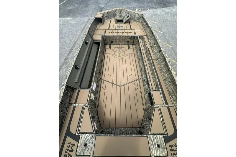 Slide: The Image of 2026 Tracker Grizzly 1756 T Marsh boat interior with camouflage design and spacious deck. - 17