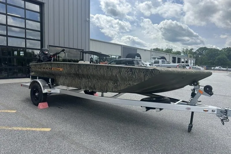 Slide: The Image of 2026 Tracker Grizzly 1756 T Marsh boat on trailer outside dealership. - 3