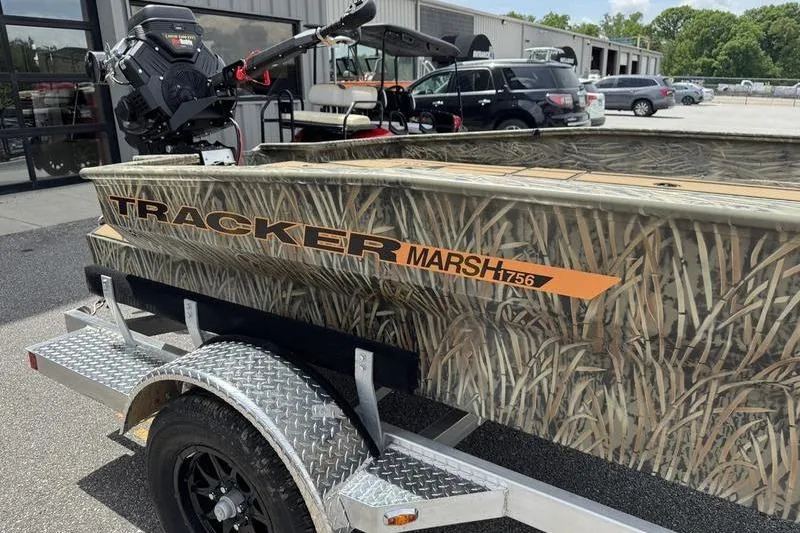 Slide: The Image of 2026 Tracker Grizzly 1756 T Marsh boat with camouflage design on a trailer. - 8