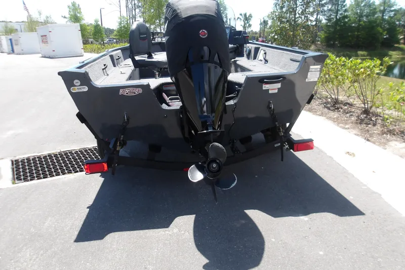 Slide: The Image of 2021 Tracker Pro Guide V-16 SC boat, rear view with motor, parked outdoors. - 10