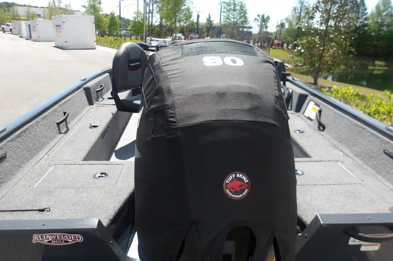 Slide: The Image of 2021 Tracker Pro Guide V-16 SC boat with Tuff Skinz engine cover, parked outdoors. - 11