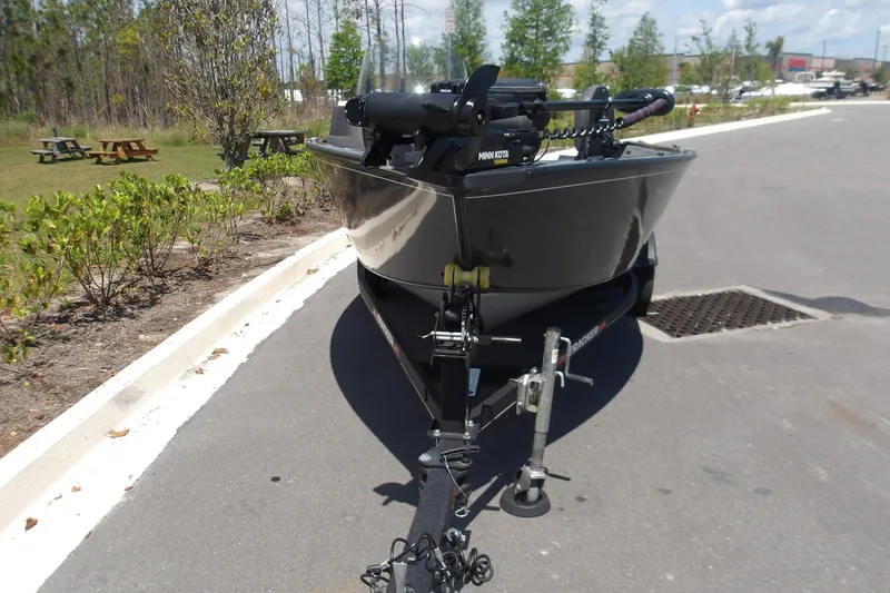 Slide: The Image of 2021 Tracker Pro Guide V-16 SC boat on trailer, parked on a sunny day. - 2