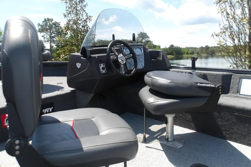 Slide: The Image of 2021 Tracker Pro Guide V-16 SC boat interior with steering console and seats. - 7