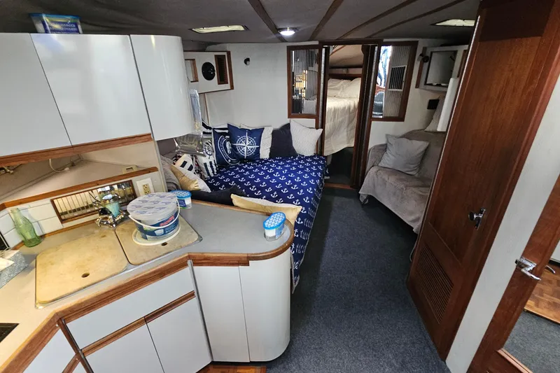 Slide: The Image of Interior of 1988 Regal Commodore 360 yacht with cozy seating and nautical decor. - 10