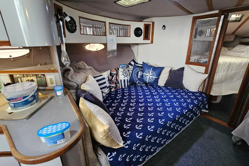 Slide: The Image of Cozy interior of a 1988 Regal Commodore 360 boat with nautical-themed decor. - 12