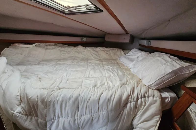 Slide: The Image of Cozy cabin bed in 1988 Regal Commodore 360 yacht with white bedding. - 14