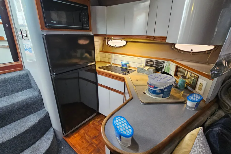 Slide: The Image of Compact kitchen in a 1988 Regal Commodore 360 yacht with modern appliances and cozy design. - 16