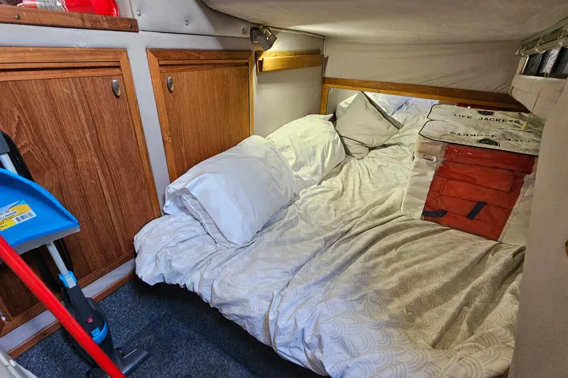 Slide: The Image of Cozy cabin interior of 1988 Regal Commodore 360 with bed and life jackets. - 18