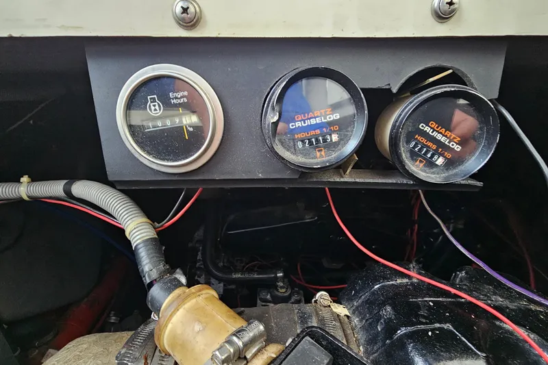 Slide: The Image of Dashboard of a 1988 Regal Commodore 360 with engine hour meters and wiring. - 23