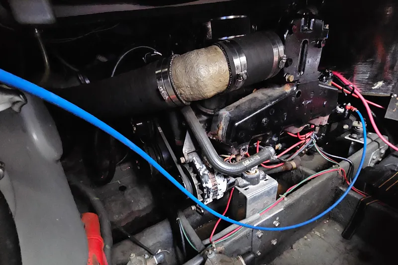 Slide: The Image of Engine compartment of a 1988 Regal Commodore 360 with visible wiring and hoses. - 24