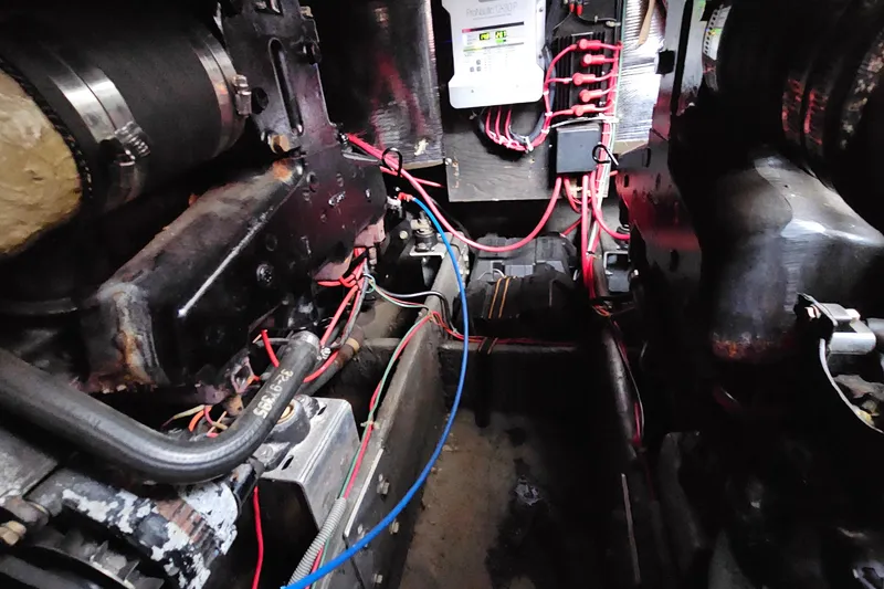 Slide: The Image of Engine compartment of a 1988 Regal Commodore 360 with visible wiring and components. - 25