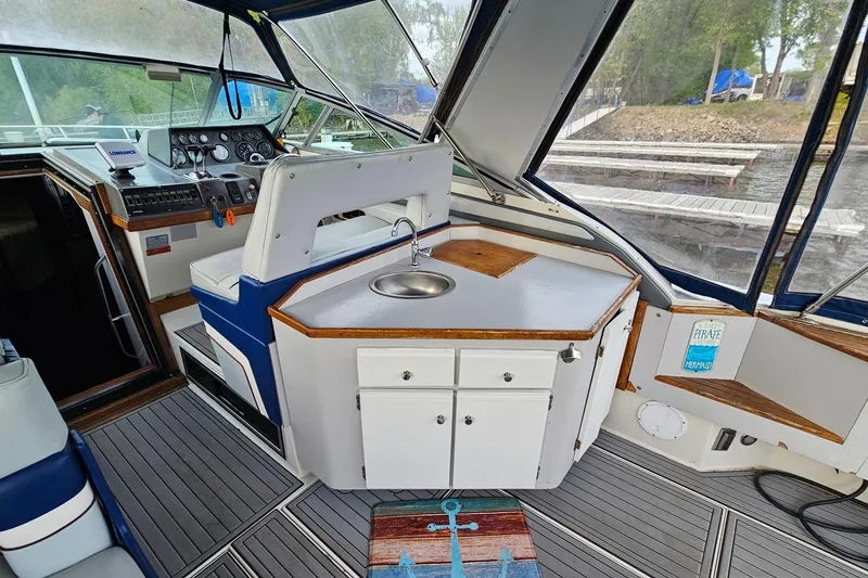 Slide: The Image of Interior of a 1988 Regal Commodore 360 boat with helm and kitchenette. - 6