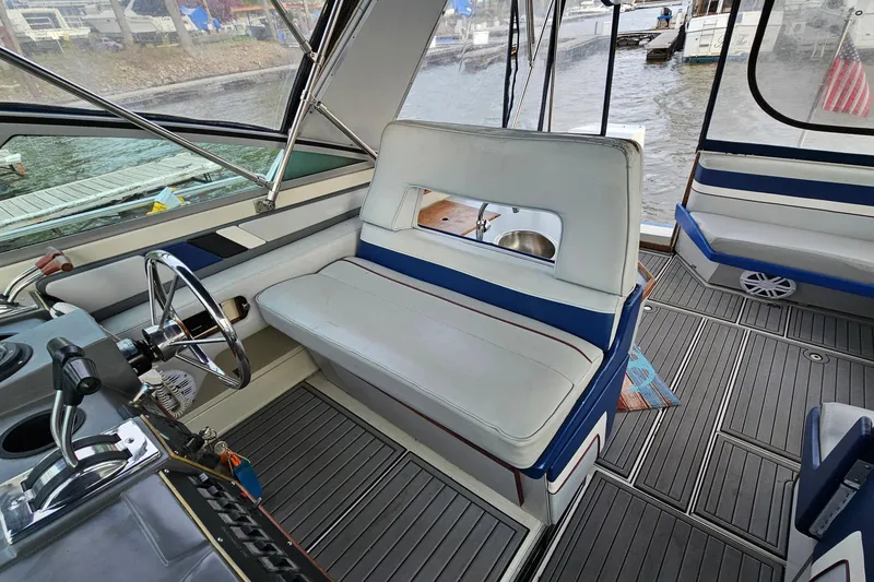 Slide: The Image of Interior of a 1988 Regal Commodore 360 boat with seating and steering wheel. - 8