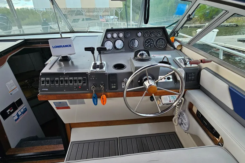 Slide: The Image of Cockpit of a 1988 Regal Commodore 360 boat with steering wheel and control panel. - 9