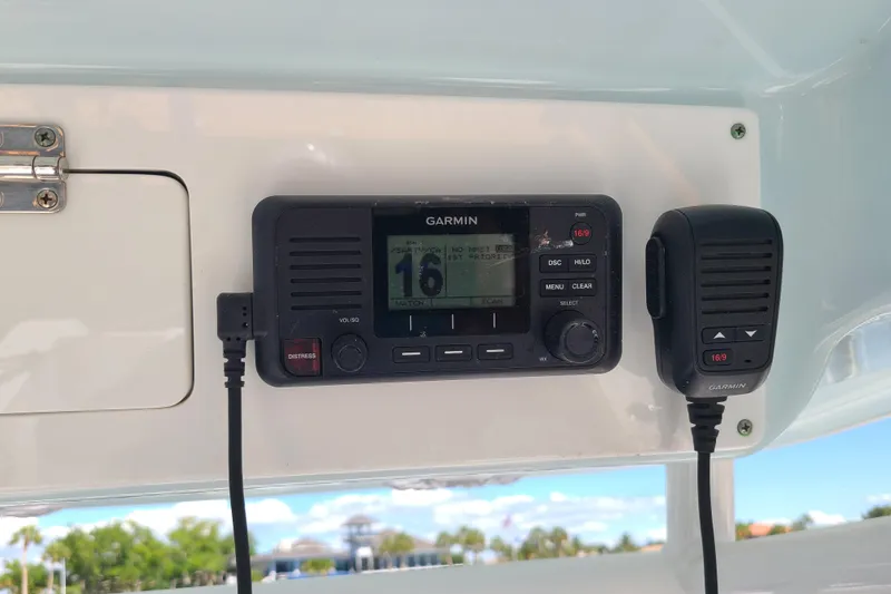 Slide: The Image of Garmin marine radio on 2021 Sportsman Open 242 Center Console boat, featuring distress button. - 11