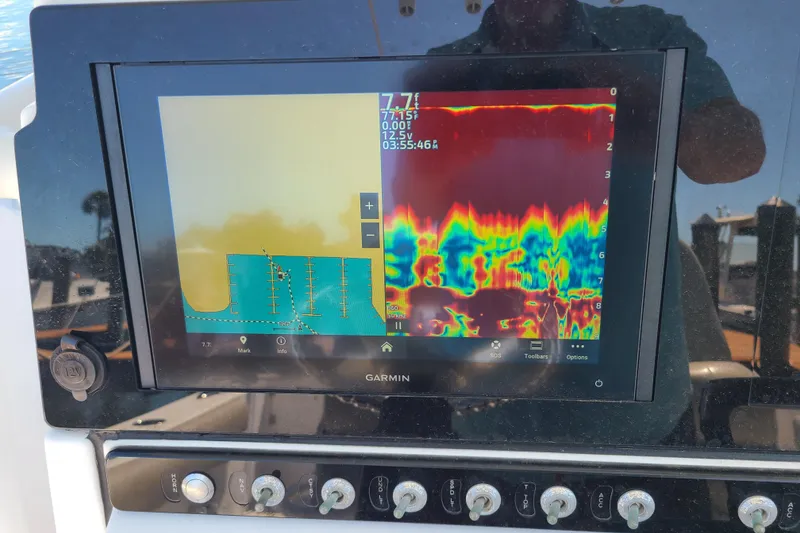 Slide: The Image of Garmin marine display on 2021 Sportsman Open 242 Center Console showing sonar and navigation data. - 12