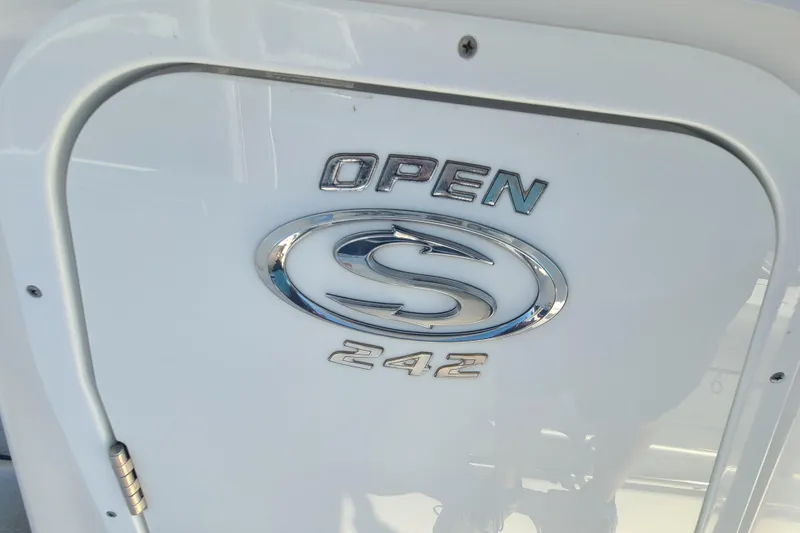 Slide: The Image of 2021 Sportsman Open 242 Center Console boat emblem on white surface. - 18
