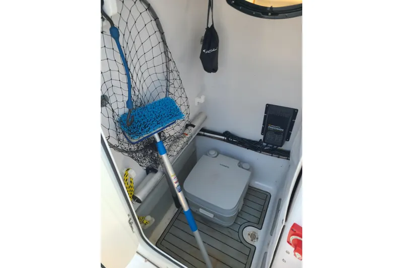 Slide: The Image of Interior of 2021 Sportsman Open 242 Center Console boat with fishing gear and equipment. - 19
