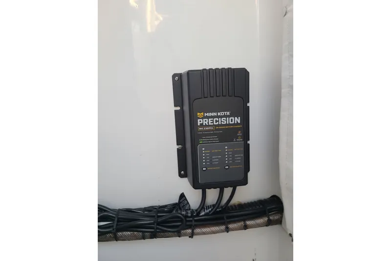 Slide: The Image of Minn Kota Precision charger installed on 2021 Sportsman Open 242 Center Console boat. - 20