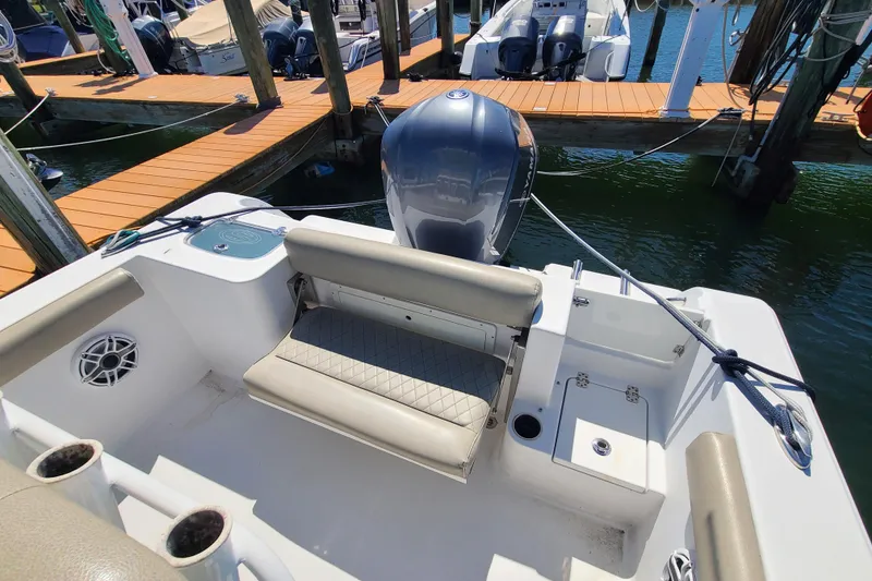 Slide: The Image of 2021 Sportsman Open 242 Center Console boat with seating and motor at dock. - 25