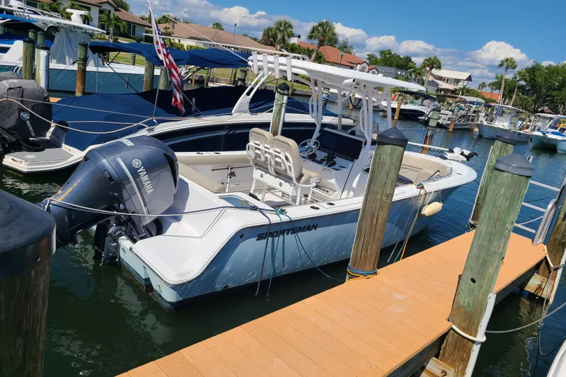 Slide: The Image of 2021 Sportsman Open 242 Center Console boat docked at marina with Yamaha engine. - 3