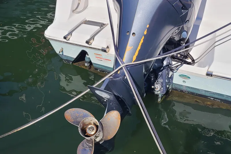 Slide: The Image of Outboard motor of 2021 Sportsman Open 242 Center Console boat with visible wear. - 30