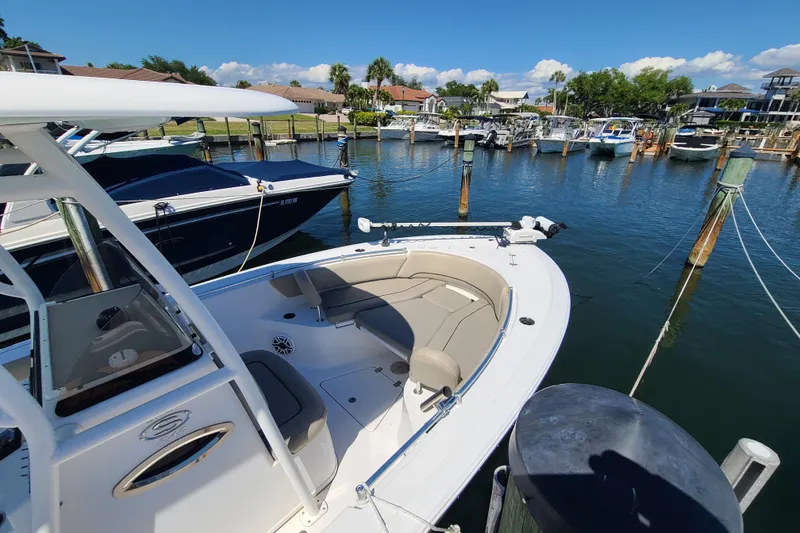 Slide: The Image of 2021 Sportsman Open 242 Center Console boat docked in a marina. - 4