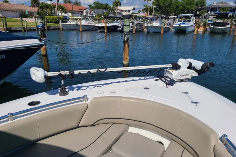 Slide: The Image of 2021 Sportsman Open 242 Center Console boat with Minn Kota trolling motor in marina. - 5