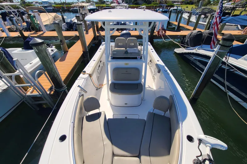 Slide: The Image of 2021 Sportsman Open 242 Center Console boat docked at a marina. - 8