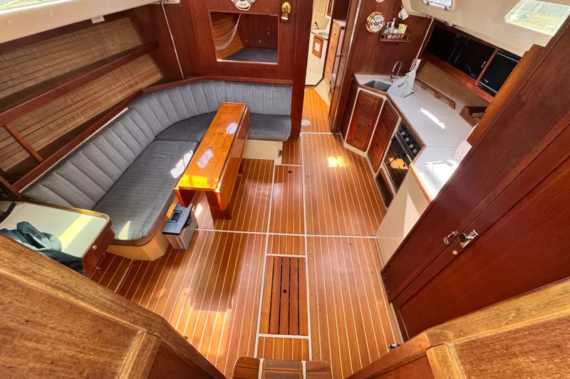 Slide: The Image of Interior of 1990 Catalina 42 MkII sailboat with wood flooring and cozy seating area. - 13