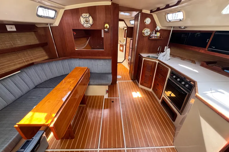 Slide: The Image of Interior of a 1990 Catalina 42 MkII sailboat with wood finishes and cozy seating. - 14