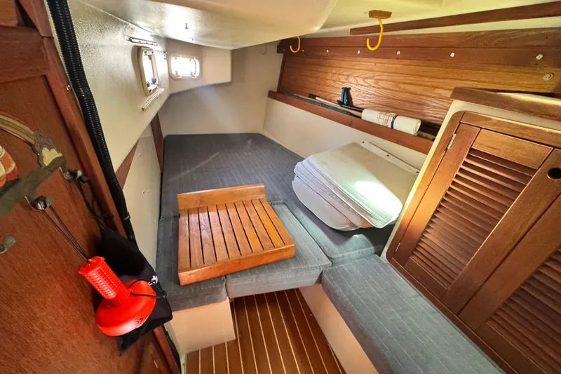 Slide: The Image of Interior cabin of a 1990 Catalina 42 MkII sailboat with wooden accents and seating. - 19