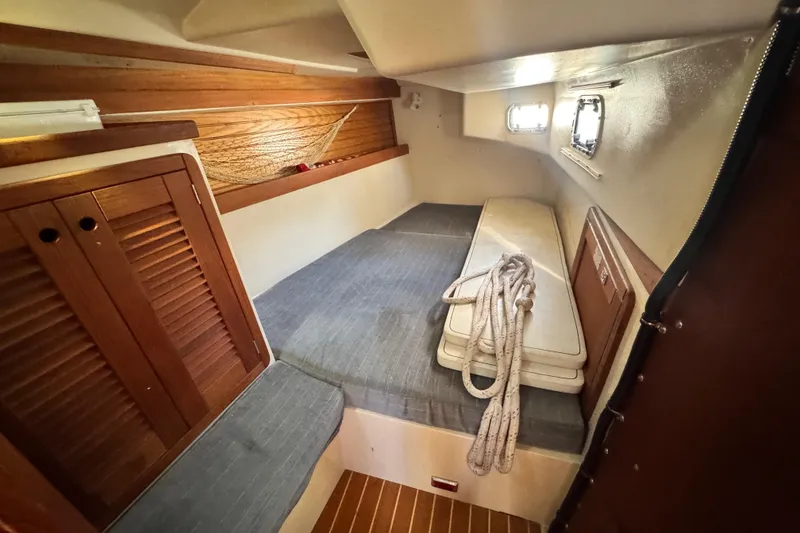 Slide: The Image of Interior cabin of a 1990 Catalina 42 MkII sailboat with wooden accents and cushions. - 21