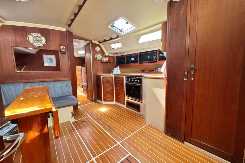 Slide: The Image of Interior of a 1990 Catalina 42 MkII sailboat with wood finishes and cozy seating area. - 22